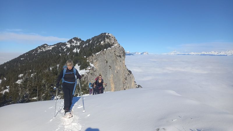 Raquettistes sur la crête au-dessus de la mer de nuages